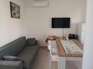 a living room with a couch and a table at At home on the coast in Torre Santa Sabina