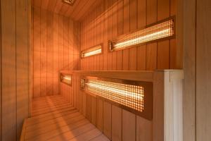 a sauna with wood paneling and lights on the wall at Giewont View Apartamenty Butikowe & Sauna Grunwaldzka by RentiloPL in Zakopane