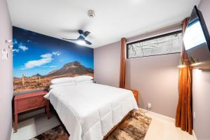 a bedroom with a bed and a window with a mountain view at Wanderstay Boutique Hotel in Houston
