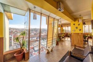 a room with a view of a city at Hotel Qalasaya in Puno