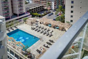 een uitzicht over een zwembad en stoelen en een hotel bij Vibrant Studio in the Heart of Waikiki! in Honolulu