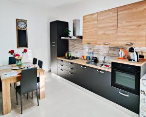 a kitchen with a table and a dining room at Valverde75 Guesthouse in Alghero