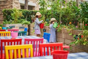 two girls in hats are standing in a garden at Montage Laguna Beach in Laguna Beach +105 photos