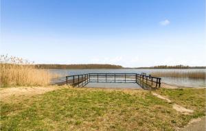 a dock in the middle of a lake at 2 Bedroom Amazing Home In Bogaczewo in Bogaczewo +10 photos