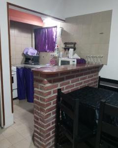 a kitchen with a brick counter top in a room at Bahía Estrada MDP in Mar del Plata