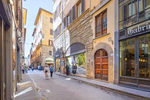 Un groupe de personnes marchant dans une rue dans l'établissement Condotta 16 Apartments, à Florence