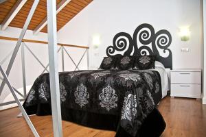 Łóżko lub łóżka w pokoju w obiekcie Apartamentos La Casa de la Alameda