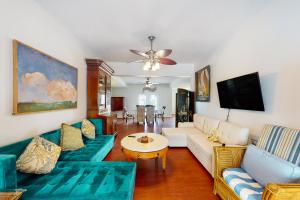 a living room with a couch and a table at Abaco House in Gulf Shores