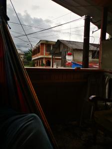 a view from the inside of a car looking at a building at LA TRANQUILIDAD in Mindo