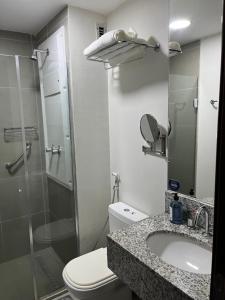 a bathroom with a toilet and a sink and a shower at Hotel Via Premiere - Rio Centro in Rio de Janeiro
