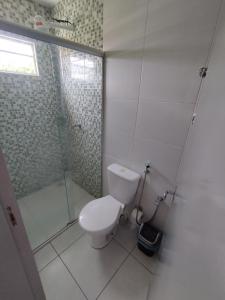 a white bathroom with a toilet and a shower at Loft charmoso na zona Leste de Teresina in Teresina