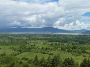 an aerial view of a field with a lake and mountains at Eco Hotel Ixhi in Pátzcuaro