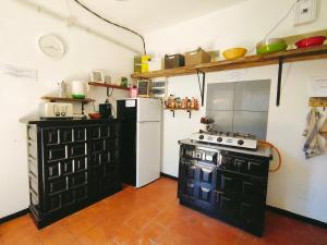 a kitchen with a black and white stove and a refrigerator at Free Canari - Los Alamos 8 in Tegueste