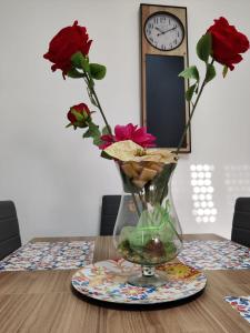 a vase with flowers in it on a table at Valverde75 Guesthouse in Alghero +3 photos
