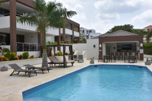 a villa with a swimming pool and a resort at Xanadu Apartments at Blue Bay Golf & Beach Resort in Willemstad