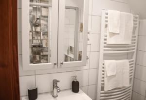 a bathroom with a sink and a mirror and towels at Dunna Vendégház in Nagymaros