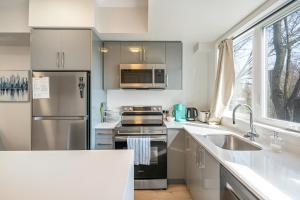a kitchen with a stainless steel refrigerator and a sink at Brand new beautiful 3 beds 2 bathroom condo in Niagara Falls
