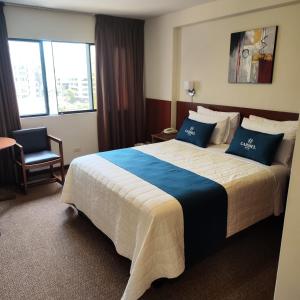 Postel nebo postele na pokoji v ubytování Hotel Carmel