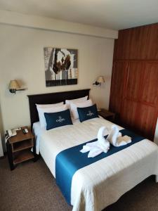 Postel nebo postele na pokoji v ubytování Hotel Carmel