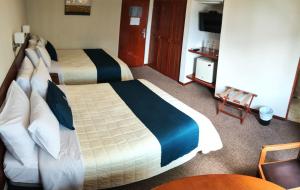 Postel nebo postele na pokoji v ubytování Hotel Carmel