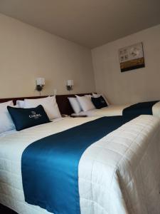 Postel nebo postele na pokoji v ubytování Hotel Carmel