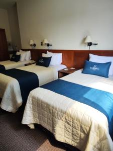 Postel nebo postele na pokoji v ubytování Hotel Carmel