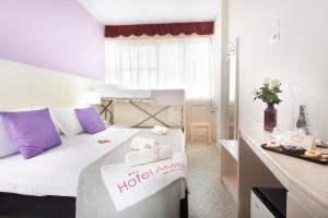 a small room with a bed with a hotel room sign on it at HOTEL AMBRA - Fronte Mare - Vicinissimi al Centro in Milano Marittima