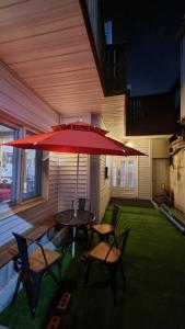 a patio with a table and chairs and an umbrella at Agit Guesthouse in Seoul