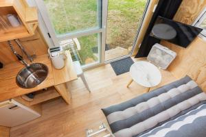 an overhead view of a tiny house with a couch and a table at Rural Couples Retreat/Tiny House in Pukehina