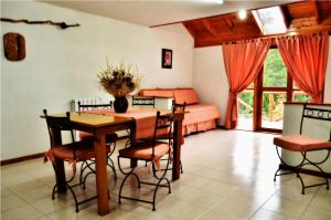 a bedroom with a table and chairs and a bed at Apart Hotel y Hosteria del Sir in Villa La Angostura