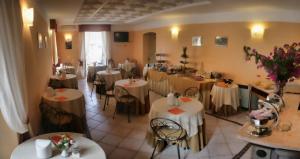 a restaurant with tables and chairs in a room at Villa Accini in Monterosso al Mare