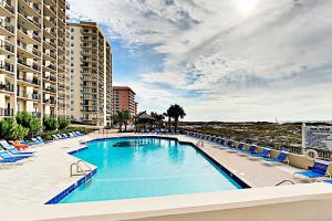 einen Pool mit Liegestühlen und ein Resort in der Unterkunft Phoenix East 801 by ALBVR - Corner unit with wrap-around balcony and unparalleled views! in Orange Beach