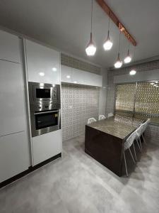a kitchen with a table and a stove top oven at Sea-side Villa in la Zenia in Alicante