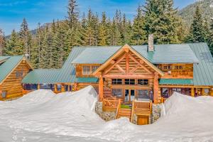 a log home with snow in front of it at Seattle Mountain Home in Snoqualmie Pass