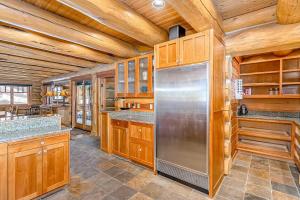 a kitchen with wooden cabinets and a stainless steel refrigerator at Seattle Mountain Home in Snoqualmie Pass