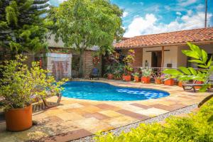 a swimming pool in the backyard of a house at Hotel Casa Canela in Barichara