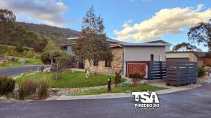 a house on the side of a road at Ski Fall at Lake Crackenback in Crackenback