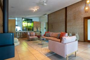 a living room with a couch and a table at Eumarella Shores Noosa Lake Retreat in Noosaville