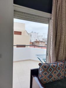 a window with a view of a balcony at apartment in centre ville in Rabat
