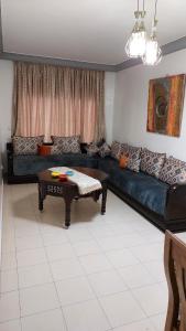 a living room with a couch and a coffee table at apartment in centre ville in Rabat