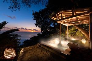 a building with a view of the ocean at night at Kissho Caren in Higashiizu +83 photos