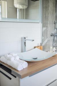 a bathroom sink with towels on a counter at Studio Mare Gaillard in Le Gosier +9 photos