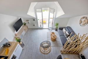 an overhead view of a living room with a couch and a table at Studio Mare Gaillard in Le Gosier