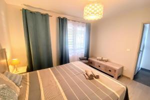a bedroom with a bed with a dog laying on it at Near Papeete modern apartment with sea view in Papeete