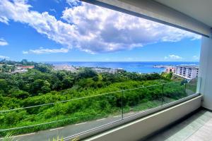 a balcony with a view of the ocean at Near Papeete modern apartment with sea view in Papeete