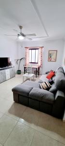 a living room with a couch and a table at ALMar We Go! Habitaciones privadas en Alcalá - Private Rooms - Pièces privées - Stanza privata in Alcalá