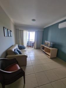 a living room with a couch and a chair at Rio Quente Aguas da Serra Apart in Rio Quente +9 photos