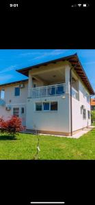 a large white house with a balcony on a yard at Dream Villa in Sarajevo
