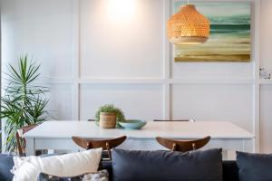 a dining room with a table and chairs at Yamba Views Angourie Views Apartment in Yamba