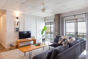 a living room with a couch and a table at Yamba Views Angourie Views Apartment in Yamba